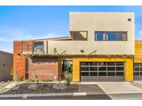 Modern home with metal and wood siding, two-car garage, and landscaped yard at 6525 E Cave Creek Rd # 9, Cave Creek, AZ 85331