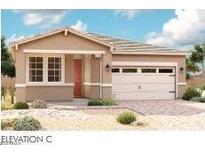 Single-story home with two-car garage and desert landscaping at 39960 W Elm Dr, Maricopa, AZ 85138