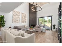 Spacious living room features a high ceiling, fireplace, and ample natural light at 4830 N 65Th St, Scottsdale, AZ 85251