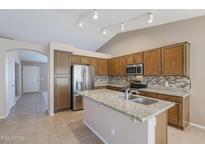 Modern kitchen with granite countertops and wooden cabinets at 7275 W Tina Ln, Glendale, AZ 85310