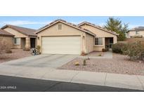 Charming single-story home with a two-car garage and desert landscaping at 21956 W Casey Ln, Buckeye, AZ 85326