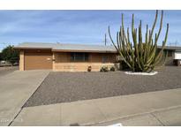 Ranch style home with carport and mature landscaping at 5702 E Casper Rd, Mesa, AZ 85205