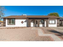 Updated single-story home with a landscaped front yard and walkway at 8840 W Desert Cove Ave, Peoria, AZ 85345
