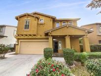 Two-story house with tan exterior, two-car garage, and landscaping at 4319 E Vaughn Ave, Gilbert, AZ 85234
