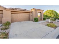 Tan two-car garage with driveway and landscaping at 4202 E Broadway Rd # 132, Mesa, AZ 85206