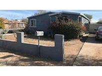 Ranch style home with a gray exterior, landscaping, and a driveway at 4431 S 5Th St, Phoenix, AZ 85040