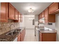 Kitchen boasts granite countertops and ample wood cabinetry at 600 S Dobson Rd # 75, Mesa, AZ 85202