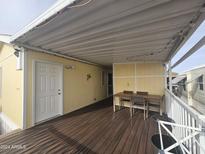 Covered deck with table and chairs, offering an outdoor space at 8700 E University Dr # 545, Mesa, AZ 85207