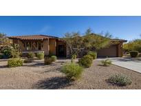 Single-story home with stucco and stone exterior, landscaped yard, and two-car garage at 32051 N 73Rd Pl, Scottsdale, AZ 85266