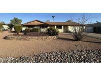 Ranch-style home with landscaped yard and rock garden at 5917 E Beryl Ave, Paradise Valley, AZ 85253