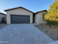 Single-story house with a two-car garage and neutral-colored exterior at 18128 N Bell Pointe Blvd, Surprise, AZ 85374