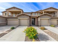 Three-unit complex with attached garages and desert landscaping at 2121 W Tallgrass Trl # 126, Phoenix, AZ 85085