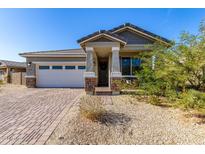Single-story home with a two-car garage and landscaped front yard at 11980 S 173Rd Ave, Goodyear, AZ 85338