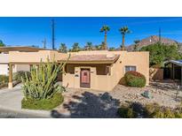 Charming stucco home with a red tile roof, landscaped yard, and a wooden door at 4620 E Montecito Ave, Phoenix, AZ 85018