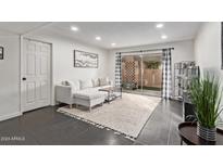 Bright living room with sectional sofa, TV, and access to a patio at 540 N May St # 1102, Mesa, AZ 85201