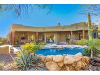 Stunning backyard oasis with a sparkling pool and relaxing desert landscaping at 5909 E Sentinel Rock Rd, Cave Creek, AZ 85331