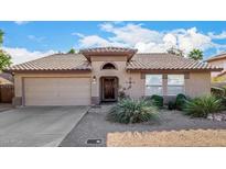 One-story house with tile roof, two-car garage, and desert landscaping at 9047 W Lisbon Ln, Peoria, AZ 85381