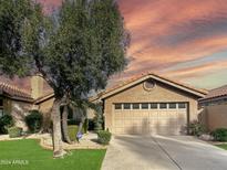Beautiful home exterior with a two-car garage and well-manicured lawn at 5016 E Marconi Ave, Scottsdale, AZ 85254