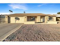 Ranch style home with a two-car garage and landscaped front yard at 610 W Medina Ave, Mesa, AZ 85210