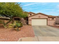 Inviting single-story home with desert landscaping and attached two-car garage at 15912 W Marconi Ave, Surprise, AZ 85374