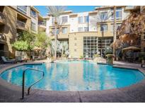 Resort-style pool with surrounding lounge chairs and landscaping at 1701 E Colter St # 156, Phoenix, AZ 85016