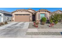 Tan two-story house with a two-car garage, landscaping, and a driveway at 2232 W Park St, Phoenix, AZ 85041