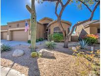 Front view of a tan house with cacti and desert landscaping at 7143 E Canyon Wren Dr, Gold Canyon, AZ 85118