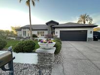 Single-story home with a landscaped yard, large driveway, and a three-car garage at 7514 N 22Nd Pl, Phoenix, AZ 85020
