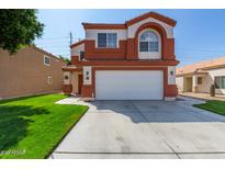 Two-story home with a two-car garage and well-maintained lawn at 12001 W Granada Rd, Avondale, AZ 85392