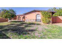 Single story home with a landscaped yard and gated entrance at 3020 E Des Moines St, Mesa, AZ 85213