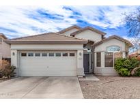 Single-story house with a two-car garage and well-maintained landscaping at 11929 W Madison St, Avondale, AZ 85323