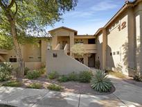 Inviting stucco exterior with shaded walkway and desert landscaping at 1351 N Pleasant Dr # 2079, Chandler, AZ 85225