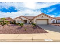 Charming single-story home with a tiled roof, desert landscaping, and a two-car garage at 16021 W Sentinel Dr, Sun City West, AZ 85375