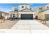 Two-story home with gray exterior, two-car garage, and landscaping at 17724 W Sanna St, Waddell, AZ 85355