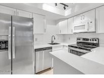 Modern kitchen with white cabinets and stainless steel appliances at 2040 S Longmore -- # 68, Mesa, AZ 85202