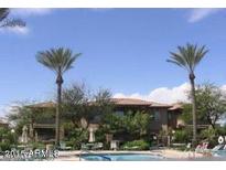 Community pool with palm trees and lounge chairs at 9100 E Raintree Dr # 130, Scottsdale, AZ 85260