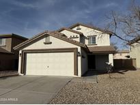 Two-story house with attached garage and desert landscaping at 22262 W Tonto St, Buckeye, AZ 85326