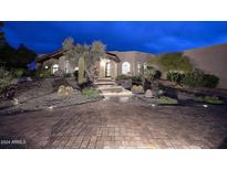 Stunning desert home with a brick driveway and beautifully landscaped front yard at 9446 E Romping Rd, Carefree, AZ 85377