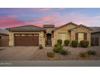 Single-story home with a two-car garage and desert landscaping at 2456 E Lindrick Dr, Gilbert, AZ 85298