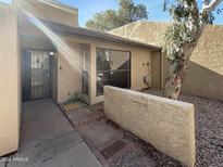 Front yard of a two-story home with a walkway, landscaping, and a tree at 3228 W Glendale Ave # 118, Phoenix, AZ 85051