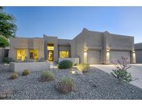 Inviting single-story home with desert landscaping and attached three-car garage at 3847 N Desert Oasis Cir, Mesa, AZ 85207