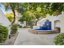 Charming courtyard with a blue tiled fountain and lush greenery at 5200 S Lakeshore Dr # 204, Tempe, AZ 85283