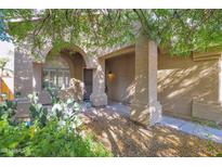Inviting front entry with arched columns, shaded porch, and desert landscaping at 4208 E Tether Trl, Phoenix, AZ 85050