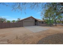 Single-story home with attached garage and desert landscaping at 501 E Desert Hills Estate Dr, Phoenix, AZ 85086