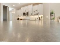 Modern kitchen with white shaker cabinets, stainless steel appliances, and a large island at 10731 E Texas Ave, Mesa, AZ 85212
