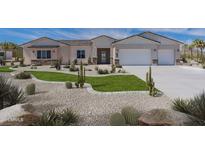 Exterior view of a single-story home with a three-car garage, desert landscaping, and a paved driveway at 1805 W Caramel Ct, Queen Creek, AZ 85144