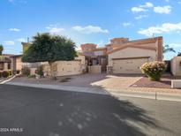 Beautiful home with a paver driveway, three-car garage, and desert landscaping at 6202 E Mckellips Rd # 66, Mesa, AZ 85215