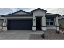 Charming single-story home with a dark gray garage door and white stone accents at 38085 W Excussare Way, Maricopa, AZ 85138