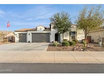 Inviting single-story home with a three-car garage and desert landscaping at 4655 N 183Rd Dr, Goodyear, AZ 85395