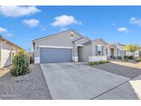 Gray house with a two-car garage and landscaped yard at 1057 W Chimes Tower Dr, Casa Grande, AZ 85122